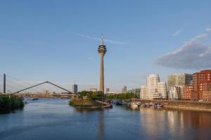 a view of a river with a tower in a city at GreenTree Inn Shanghai South Railway Station Xujiahui Stadium Subway Station Shell Hotel in Shanghai