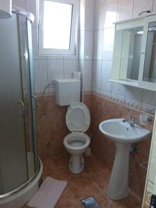 a bathroom with a toilet and a sink at Apartmani Simonovic in Sutomore