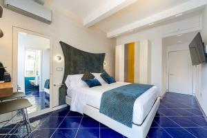 a bedroom with a bed and a tv in it at La Suite Del Cavaliere in Amalfi