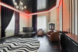 a living room with a couch and a fireplace at Hotel Alberia in Pyatigorsk