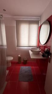 a red bathroom with a sink and a toilet at Casa Regina Tenerife in Tamaimo +32 photos
