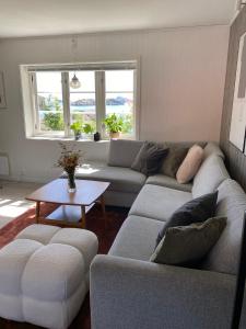 a living room with two couches and a table at Lofoten Sea Lodge in Sennesvik