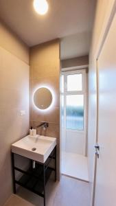 a bathroom with a sink and a window at Hotel Tritone in Trieste