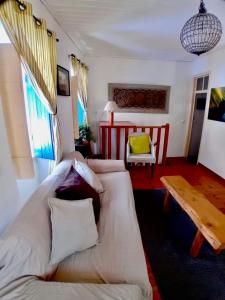 a living room with a couch and a table at The Corner House - Charming Rustic Home in the Heart of Monchique in Monchique