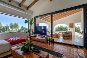 a living room with a large sliding glass door leading to a patio at Naraya - Managed By Almarina Villas in Jávea