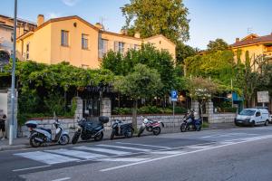 a row of motorcycles parked on the side of a street at Hotel Tritone in Trieste