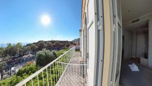a balcony of a building with a view of a street at Hotel Tritone in Trieste