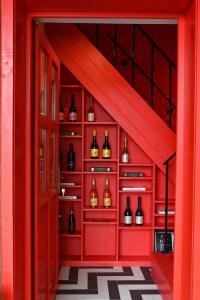 a red room with wine bottles on shelves at Bohém Borklub in Tállya