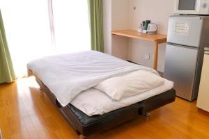 Postel nebo postele na pokoji v ubytování ホテル西川口ウィークリー