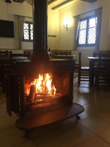 a fire burning in a room with a fireplace at Hostal de Montaña la Casa Grande in Nogueruelas