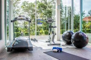 a gym with cardio equipment and a large window at Royal Lee Resort and Spa in Ban Bo Han