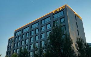 a building with a sign on the top of it at Harbin Ju Jian Hotel in Harbin