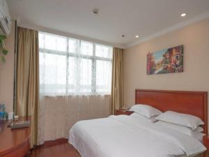 Ένα ή περισσότερα κρεβάτια σε δωμάτιο στο GreenTree Inn Wuhu Fangte Second Phase Nanxiang Wanshang Express Hotel