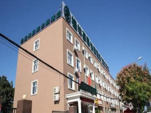 a large brick building on a city street at GreenTree Inn Yanjiao Haiyou Street Yanchang Road Express Hotel in Gaolou
