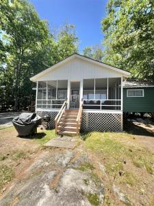 a small house with a boat in front of it at PLACYD PINES LIMIT 8 cottage in North Sebago