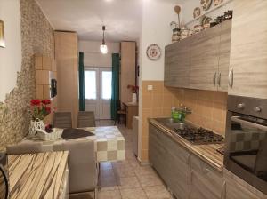 a kitchen with a sink and a stove top oven at Krisztinusz Vendégház in Fonyód