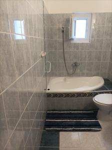 a bathroom with a shower and a tub and a toilet at Krisztinusz Vendégház in Fonyód +9 photos