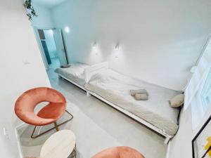 a room with two beds and a chair in it at Apartman DE LUX RADIVOJEVIĆ in Sutomore