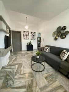 a living room with a couch and a table at Zandre Luxury Suites in Skiros