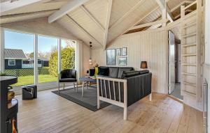 a living room with a couch and a table at 2 Bedroom Stunning Home In Odder in Odder