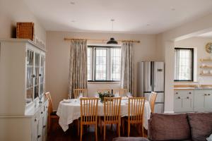 a kitchen with a table with chairs and a refrigerator at The Courtyard at Manor Estate near Stonehenge in Salisbury
