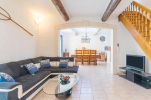 a living room with a couch and a tv at Mas Provençal in Saint-Rémy-de-Provence