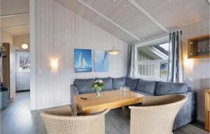 a living room with a table and a couch at Frische Brise 20 - Dorf 3 in Priwall