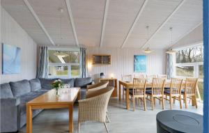a living room with a couch and a table and chairs at Frische Brise 20 - Dorf 3 in Priwall