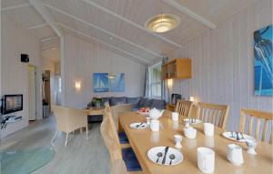 a dining room and living room with a table and chairs at Frische Brise 20 - Dorf 3 in Priwall +21 photos