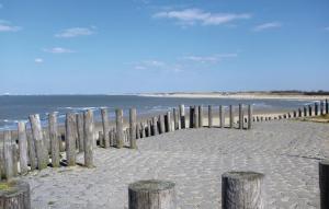 a wooden fence on a beach near the ocean at Stunning Home In Breskens With Wifi in Breskens