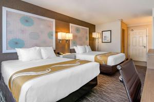 A bed or beds in a room at Quality Inn