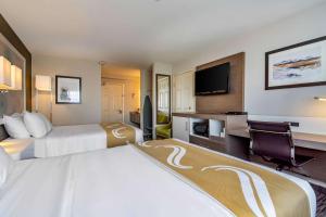A bed or beds in a room at Quality Inn