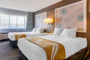 A bed or beds in a room at Quality Inn