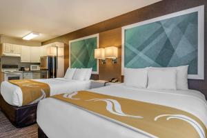 A bed or beds in a room at Quality Inn
