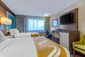 A bed or beds in a room at Quality Inn