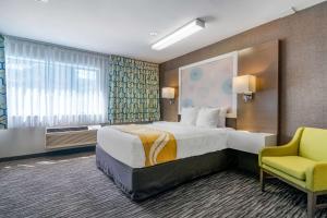 A bed or beds in a room at Quality Inn