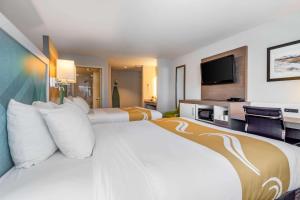 A bed or beds in a room at Quality Inn