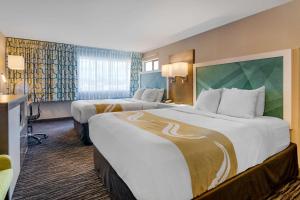 A bed or beds in a room at Quality Inn