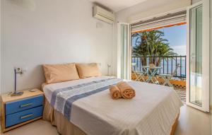 a bedroom with a bed with two towels on it at Nice Home In San Javier With Wifi in San Javier +18 photos