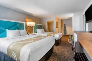 A bed or beds in a room at Quality Inn