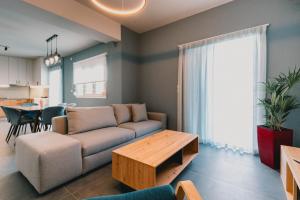 a living room with a couch and a table at Charys Premium Home in Preveza