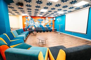 a room with blue chairs and a projection screen at Abraham Tel Aviv in Tel Aviv