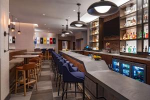 a bar with a row of tables and chairs at Hyatt Place Indianapolis Downtown in Indianapolis