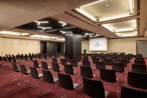 a conference room with chairs and a screen in it at Hilton Rome Eur La Lama in Rome
