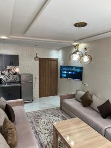 a living room with two couches and a kitchen at Oualidia city in Oualidia