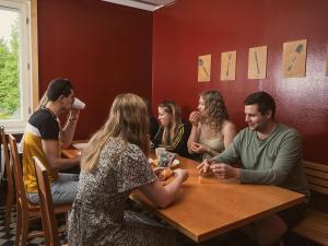 a group of people sitting at a table in a restaurant at Eurohostel in Helsinki