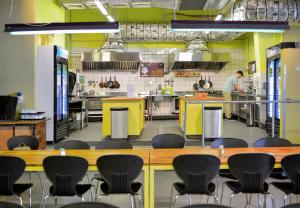 a kitchen with a chef preparing food in the kitchen at Abraham Tel Aviv in Tel Aviv