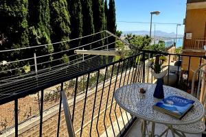 a table with a book on it on a balcony at Casa dei Venti in Porto Palo