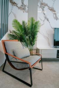 a chair with a plant in a room at Sol Mate Luxury Villa in Nikiti