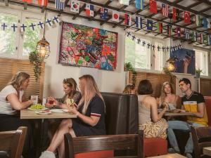 a group of people sitting at a table in a restaurant at Eurohostel in Helsinki